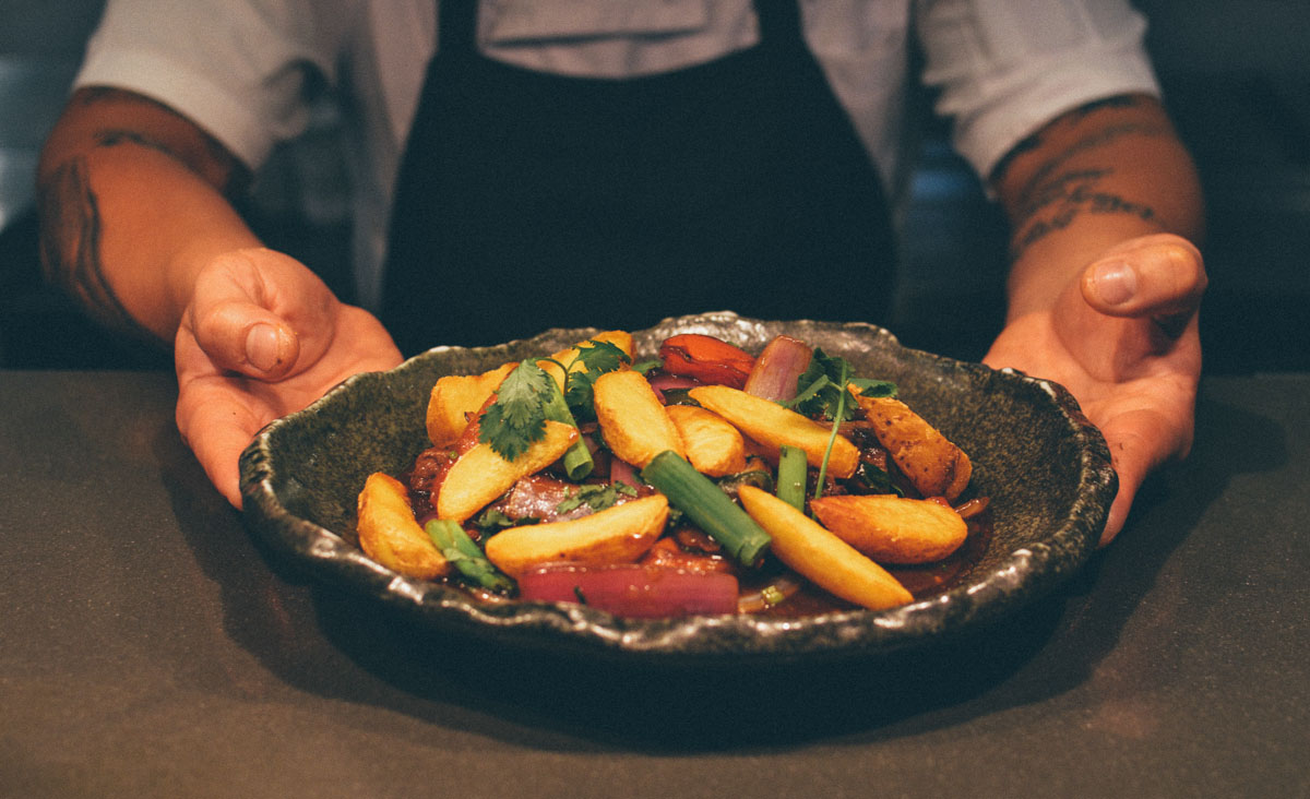 Chef seasoning a dish